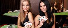 Two dealers with poker cards in hand.