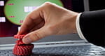 Image of a roulette chips on the keyboard of a laptop.