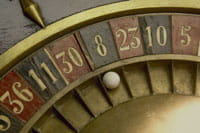 Close-up of an old roulette wheel and a ball.