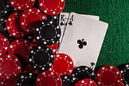 Casino chips and cards on a blackjack table.