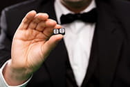 A dealer holds two dice.