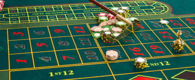 The dealer removes the chips with which the bets have been placed from the mat with the rake.