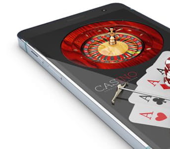 Mobile phone on the screen of which an online casino game is viewed.