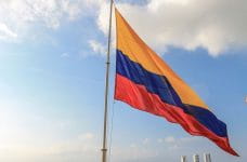 Flag of Colombia waving hoisted on a mast.